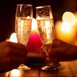 114740261-rendezvous-champagne-glass-christmas-tree-toasting-drinking